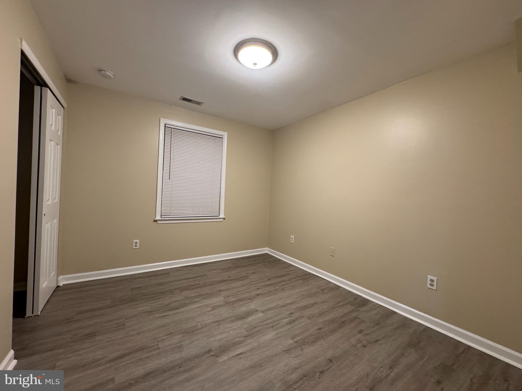 522 A Merchant Street, Unit A Cherry Hill, NJ 08002 - Photo 11 of 24 an empty room with wooden floor and windows