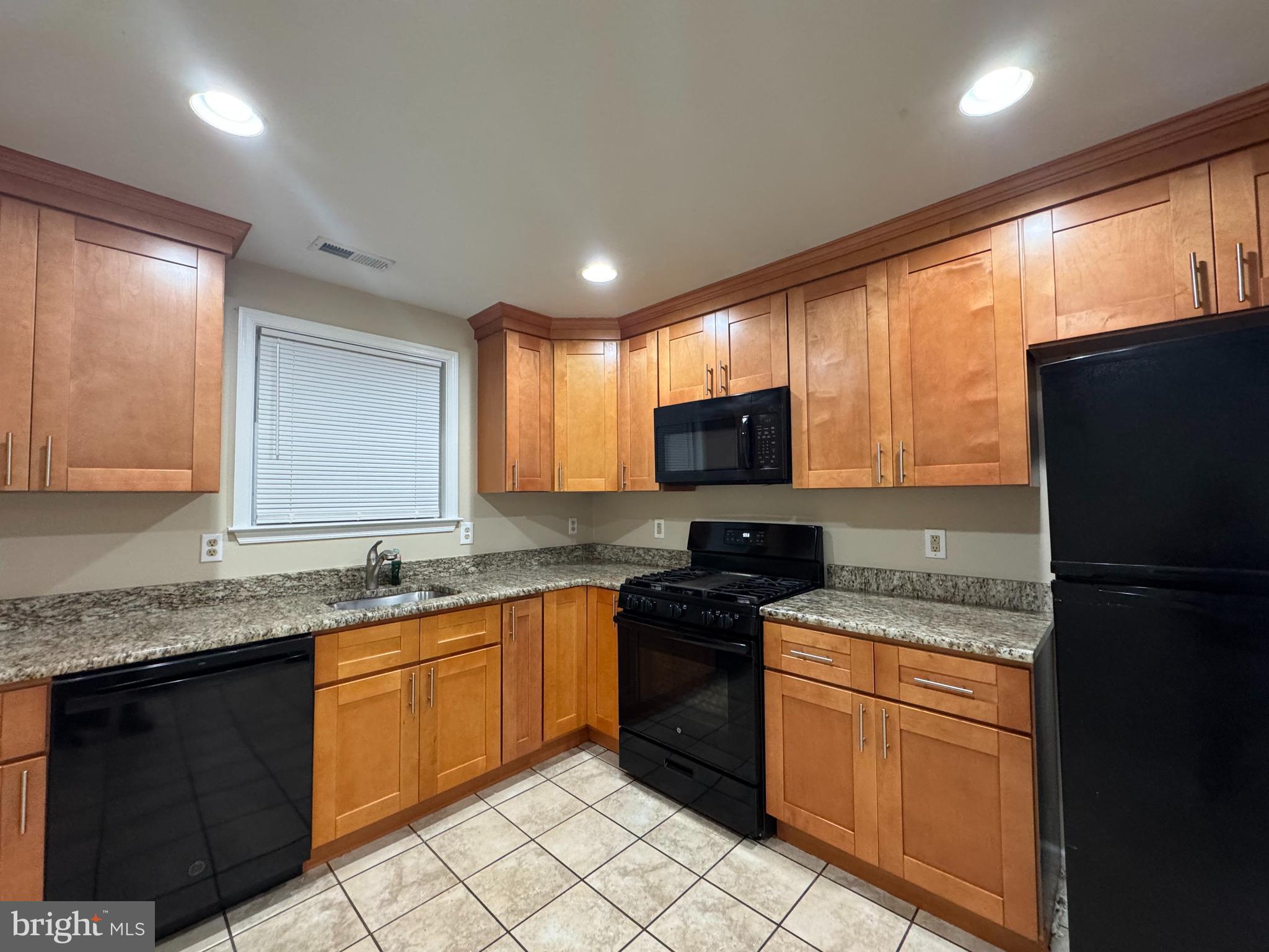 522 A Merchant Street, Unit A Cherry Hill, NJ 08002 - Photo 19 of 24 a kitchen with stainless steel appliances granite countertop a stove a sink dishwasher a refrigerator and a microwave
