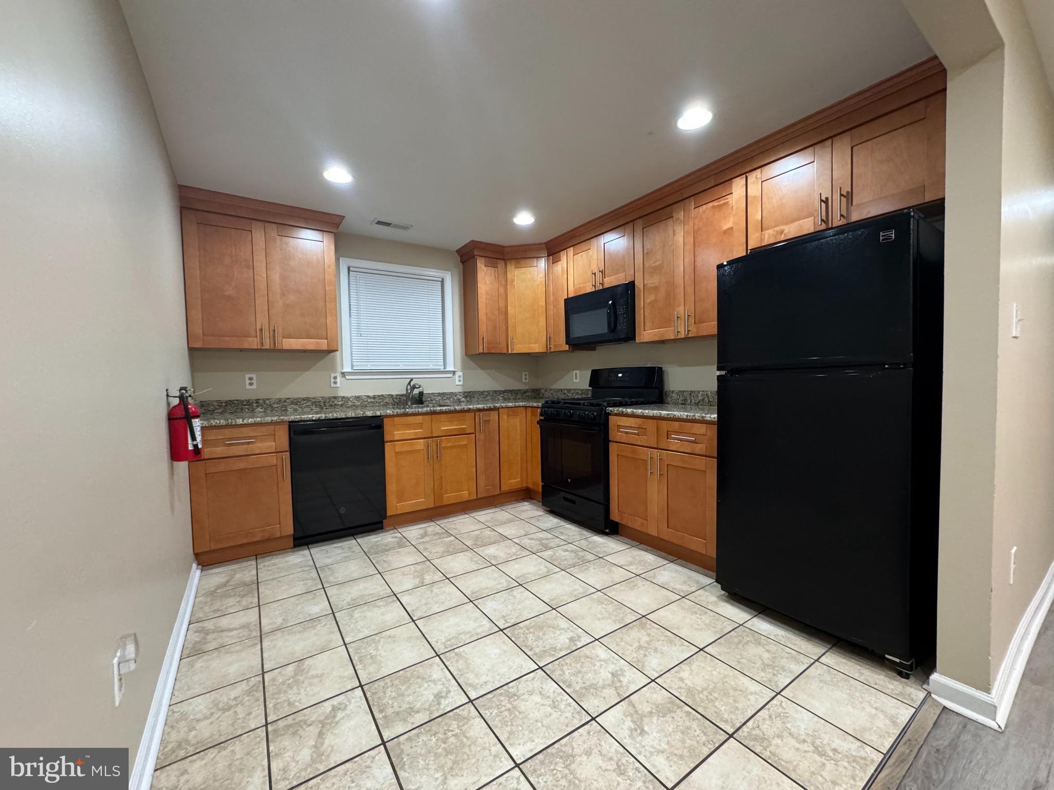522 A Merchant Street, Unit A Cherry Hill, NJ 08002 - Photo 3 of 24 a kitchen with granite countertop stainless steel appliances and white cabinets