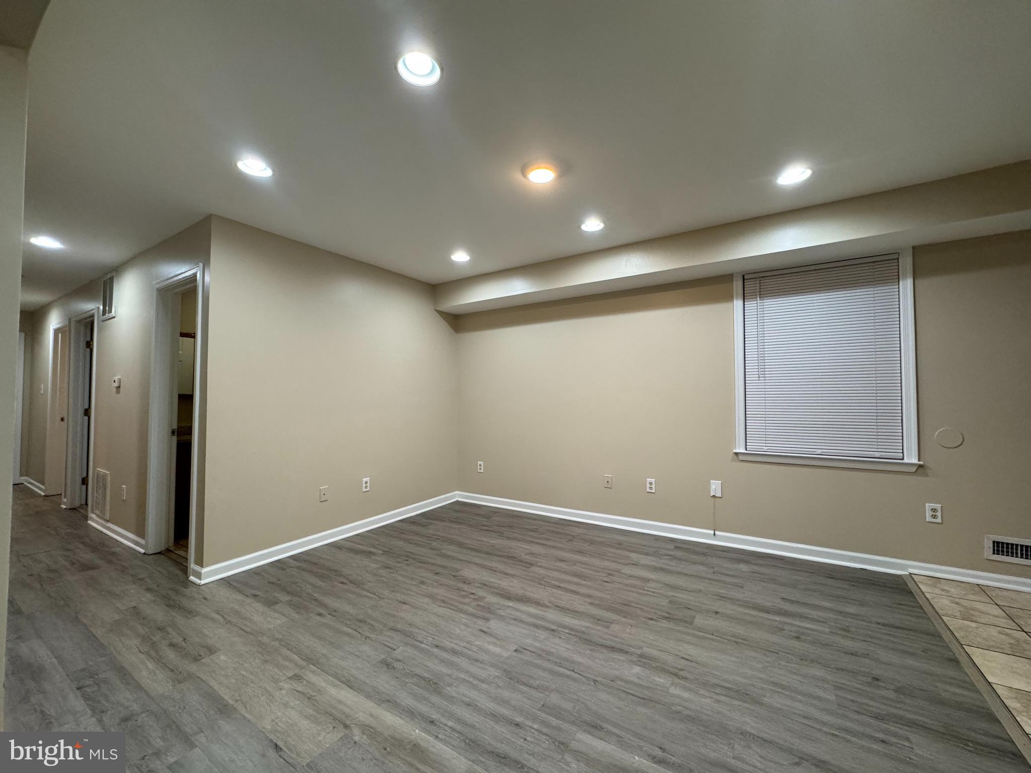 522 A Merchant Street, Unit A Cherry Hill, NJ 08002 - Photo 4 of 24 an empty room with wooden floor and windows