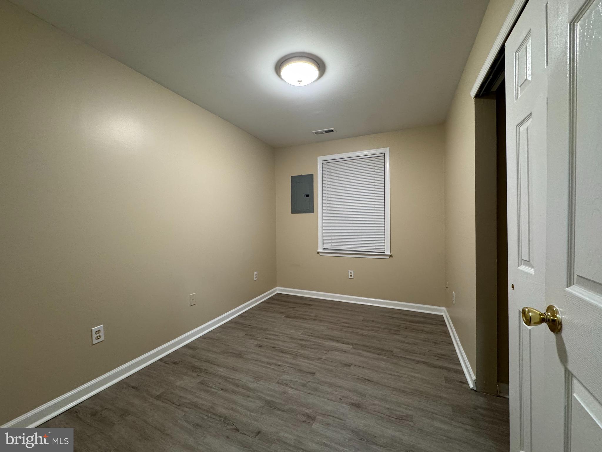 522 A Merchant Street, Unit A Cherry Hill, NJ 08002 - Photo 8 of 24 an empty room with wooden floor and windows
