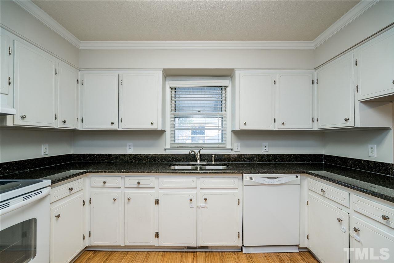 714 New Road Raleigh, NC 27608 - Photo 13 of 25 Kitchen sink with window overlooking carport area off the side of the house.