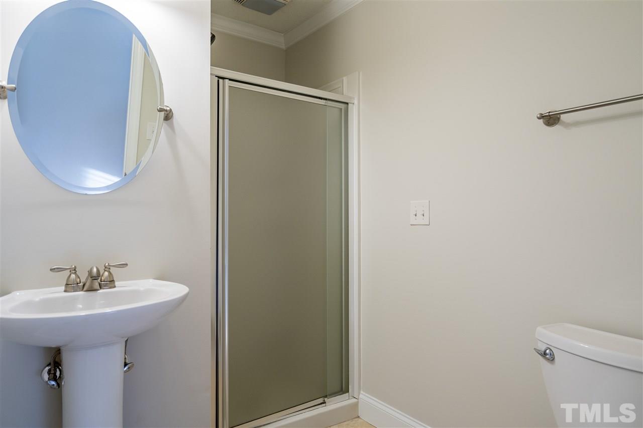 714 New Road Raleigh, NC 27608 - Photo 17 of 25 En suite bathroom is tucked inside the owner's bedroom retreat.