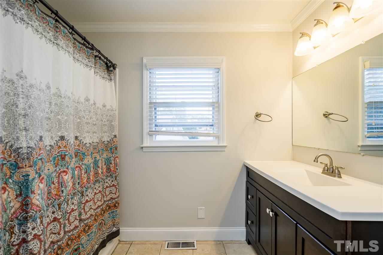 714 New Road Raleigh, NC 27608 - Photo 19 of 25 Hall bathroom features an oversized bathtub, tile and modern sink!