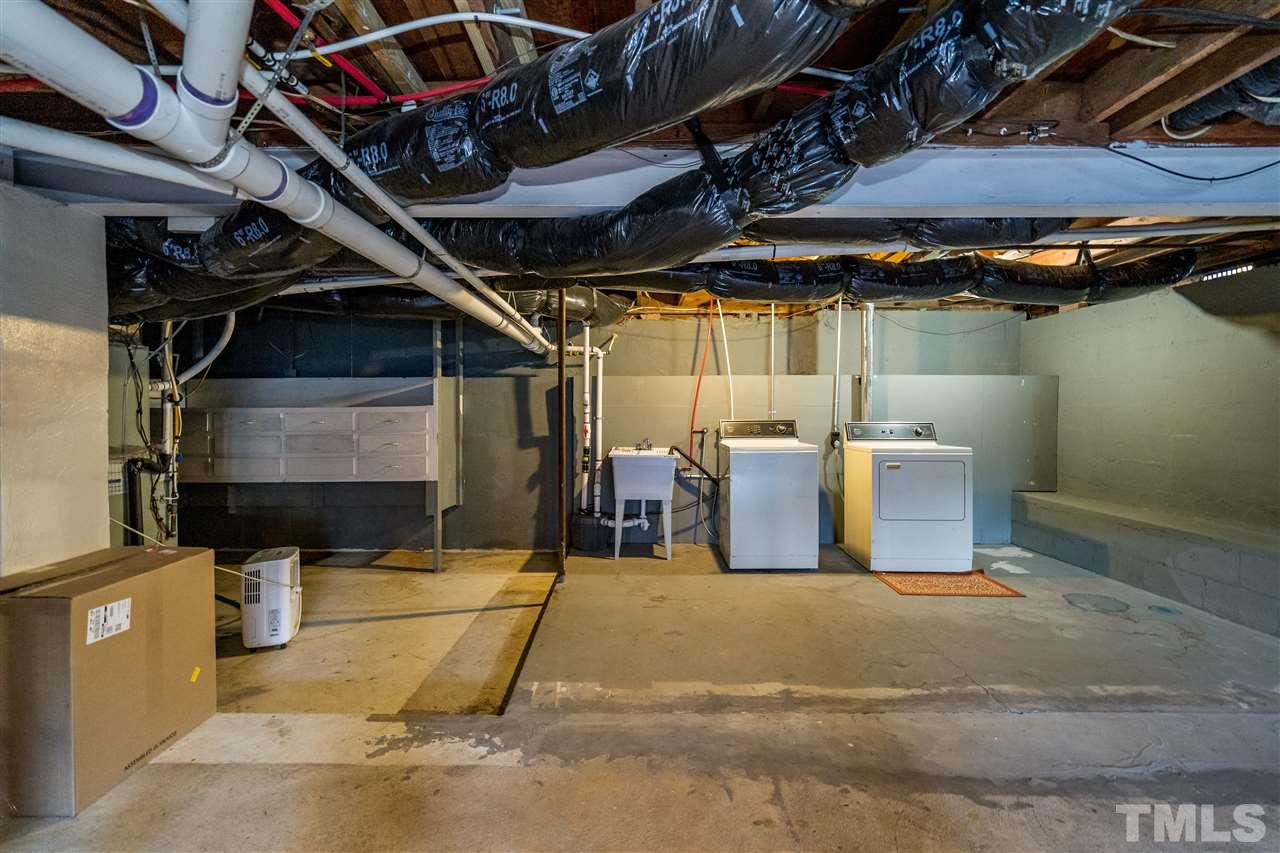 714 New Road Raleigh, NC 27608 - Photo 21 of 25 Unfinished basement space is used for laundry and tons of additional square footage for a workout area, play area, storage of yard supplies/bikes/canoes.