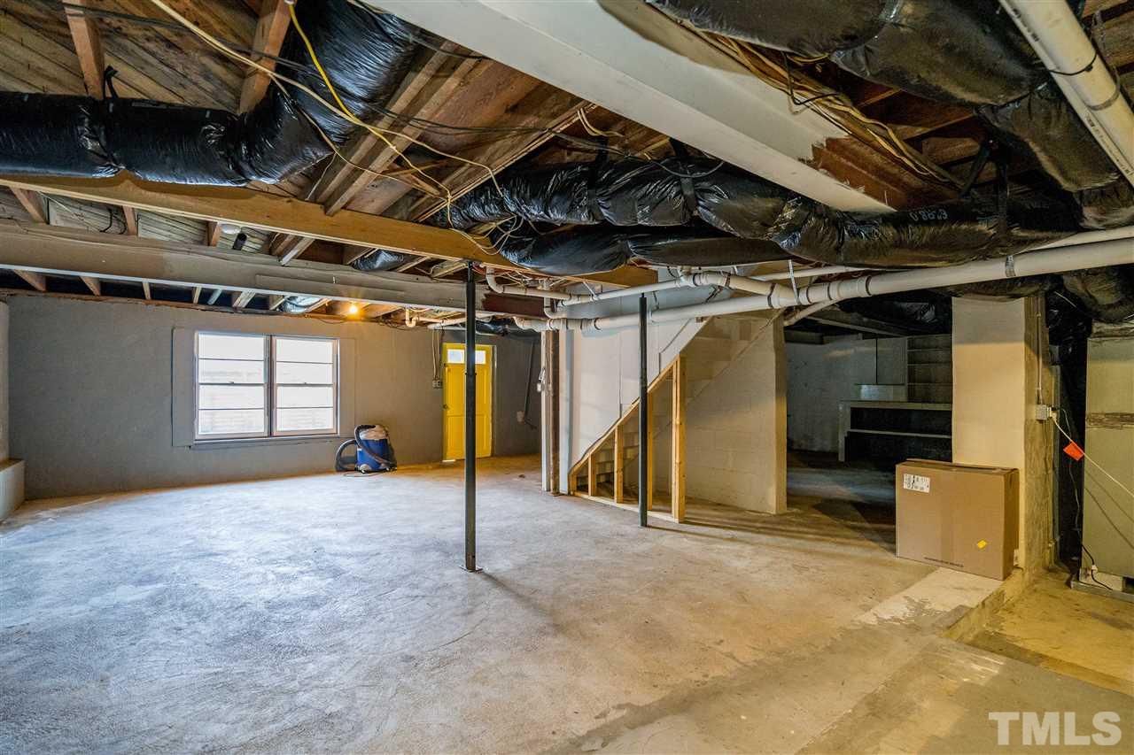 714 New Road Raleigh, NC 27608 - Photo 22 of 25 Unfinished basement space is used for laundry and tons of additional square footage for a workout area, play area, storage of yard supplies/bikes/canoes.
