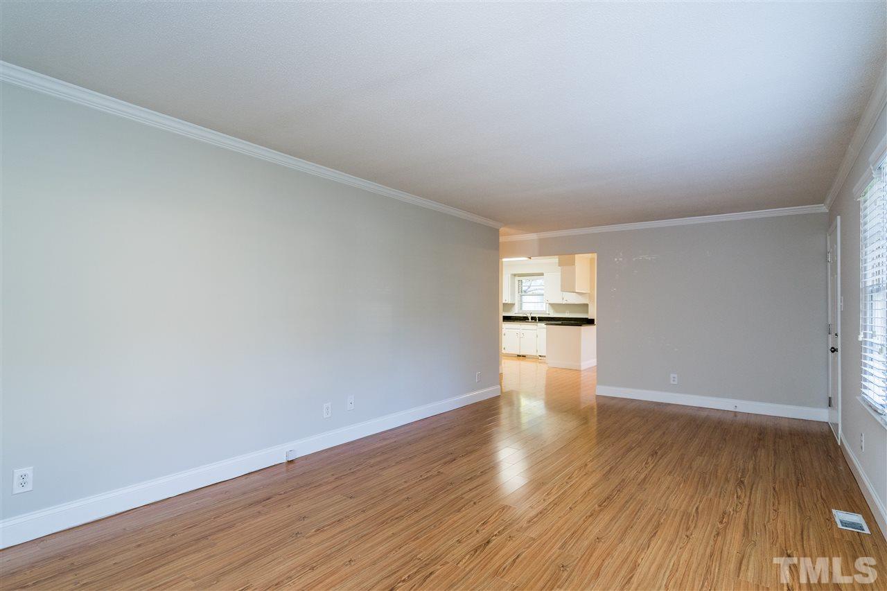 714 New Road Raleigh, NC 27608 - Photo 7 of 25 Make way for the kitchen! Living room opens to kitchen and eating nook. Consistent flooring and wall color make this house live large!