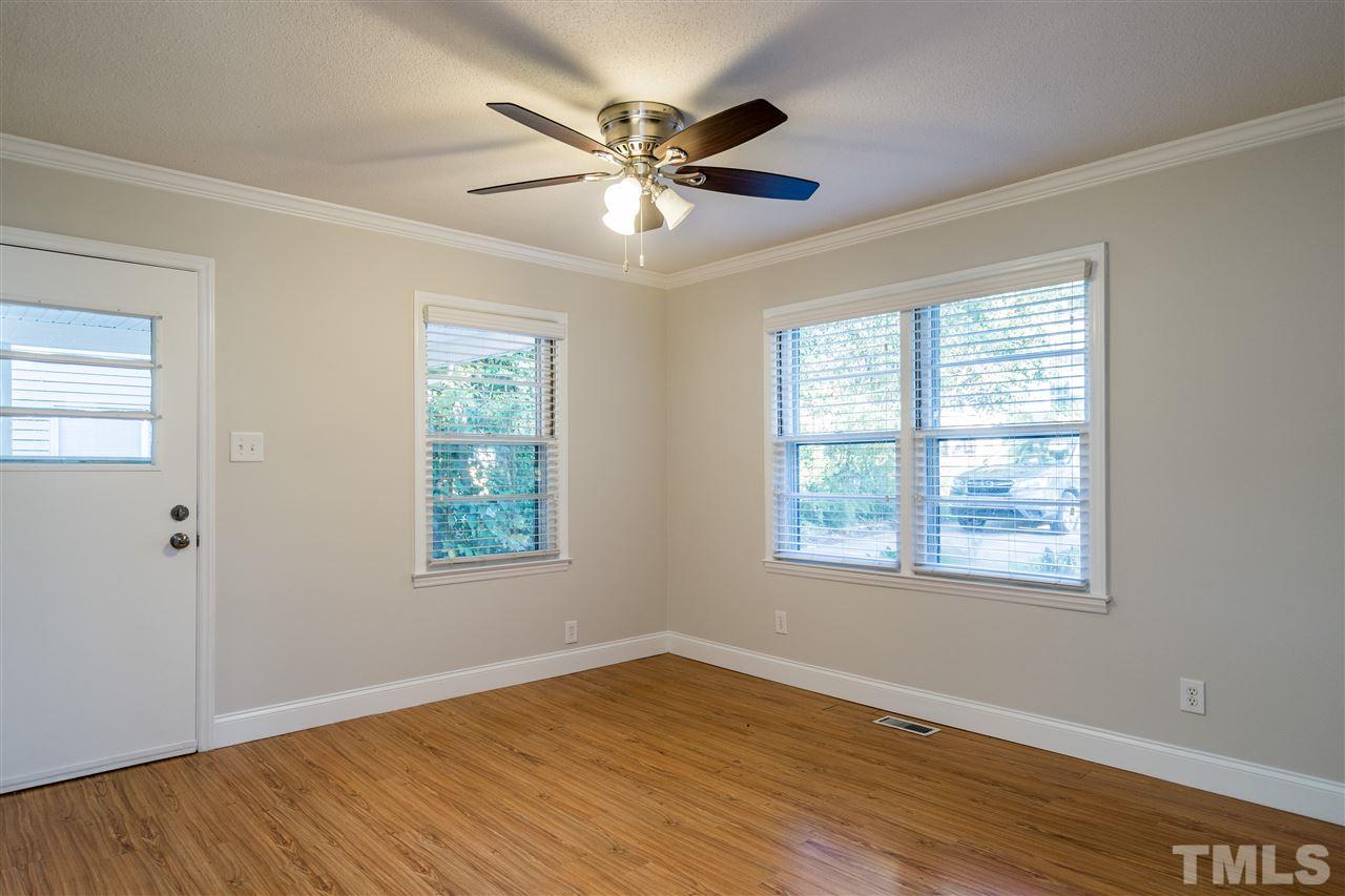 714 New Road Raleigh, NC 27608 - Photo 9 of 25 Dining area alongside the kitchen with ceiling fan and side door make coming in out and with groceries a breeze!