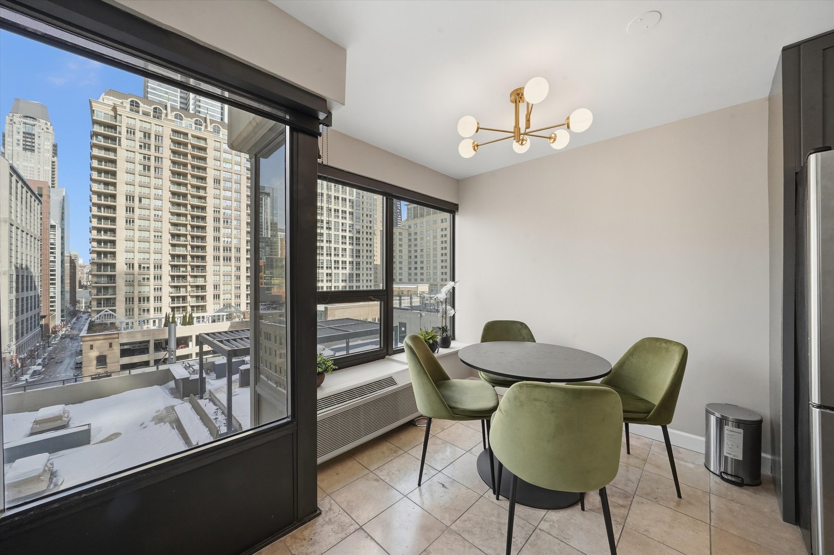 30 East Huron Street, Unit 907 Chicago, IL 60611 - Photo 6 of 13 a view of a dining room with furniture and a window