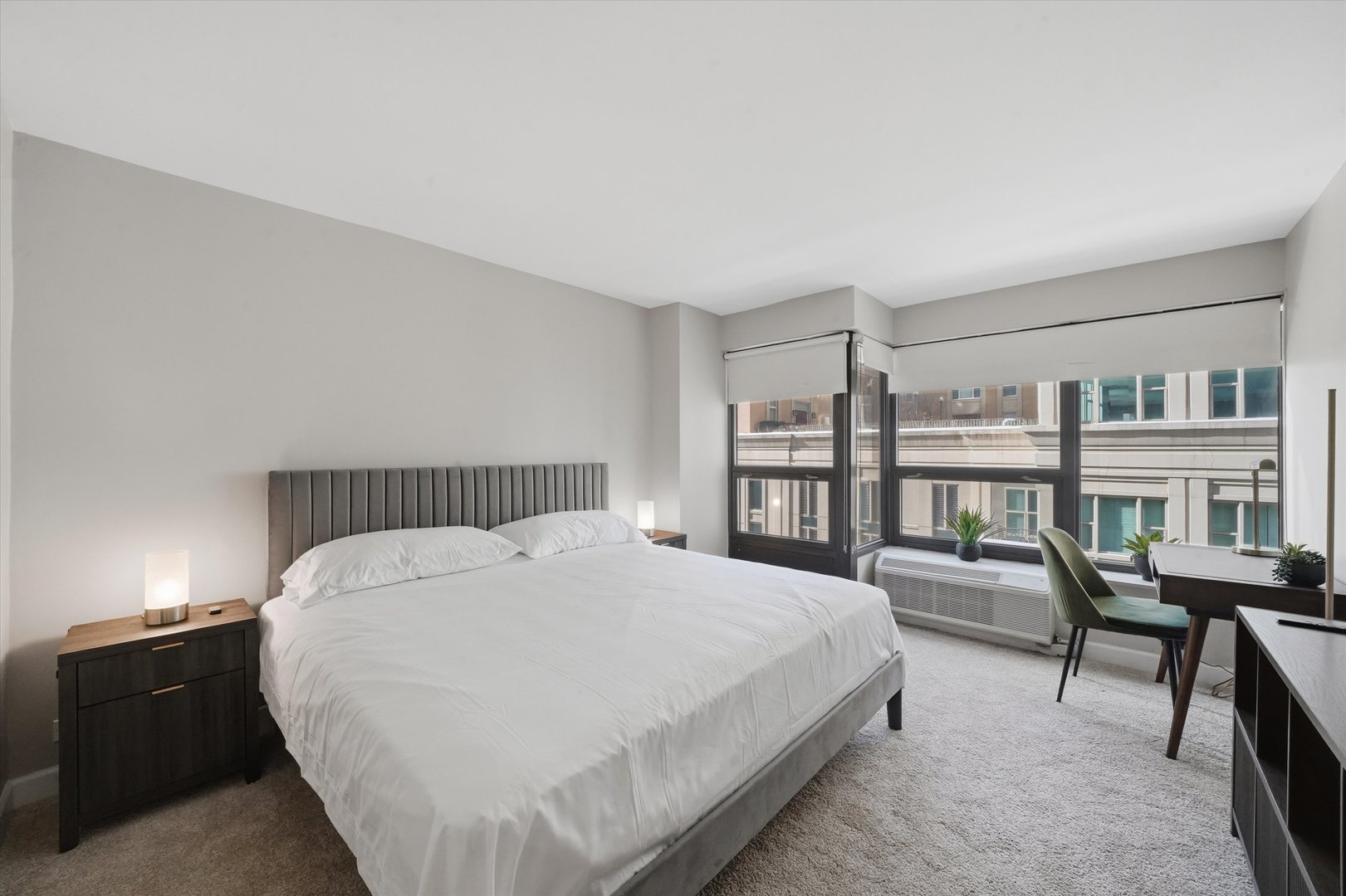 30 East Huron Street, Unit 907 Chicago, IL 60611 - Photo 7 of 13 a spacious bedroom with a bed a table and a book shelf