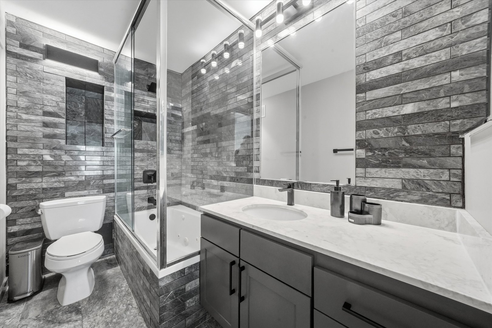 30 East Huron Street, Unit 907 Chicago, IL 60611 - Photo 9 of 13 a bathroom with a sink a toilet and shower