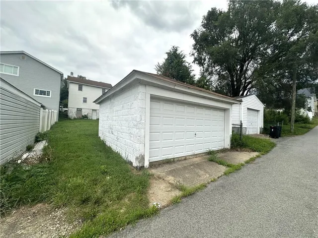 a view of backyard of house and garage