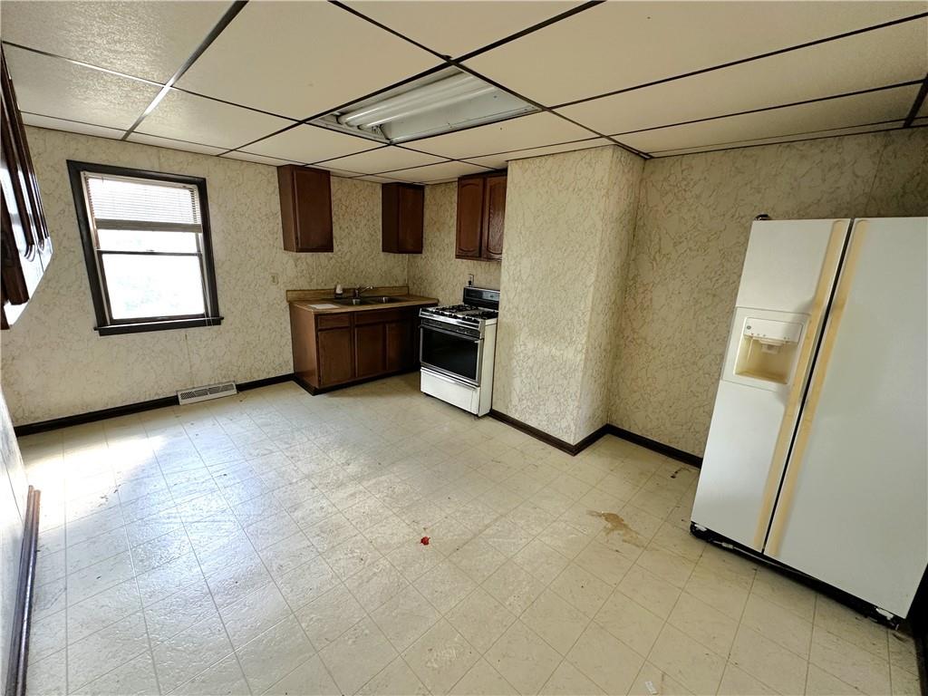 604 8th Street Irwin, PA 15642 - Photo 5 of 12 a view of a refrigerator and window in a room