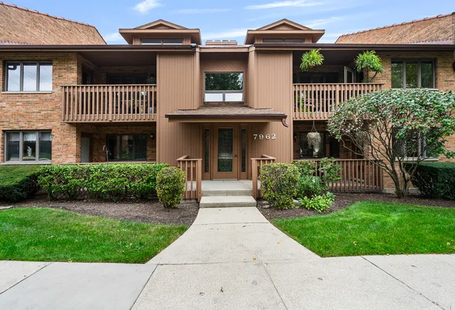 a front view of a house with a garden