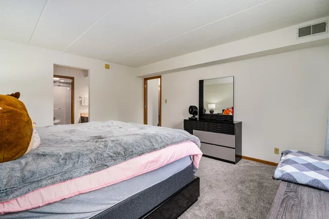 a bedroom with a bed and a mirror