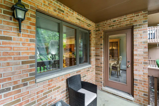front view of a brick house with large windows