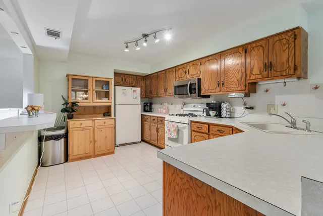 a kitchen with stainless steel appliances a refrigerator sink and cabinets