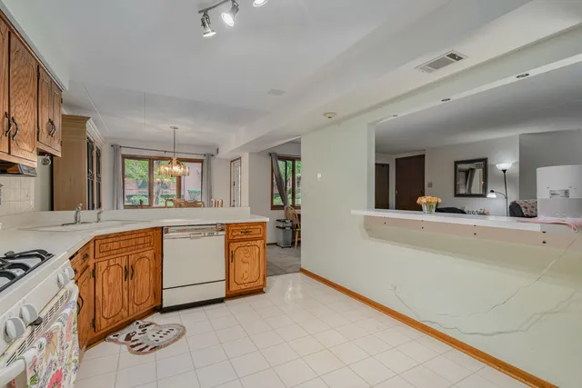a large white kitchen with a large window