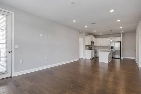 a view of kitchen with kitchen island and stainless steel appliances