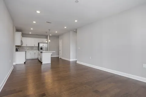 a view of kitchen dining table chairs microwave and cabinets
