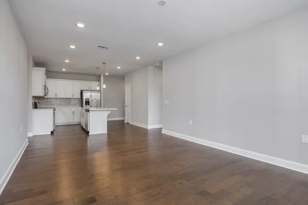 a view of kitchen dining table chairs microwave and cabinets