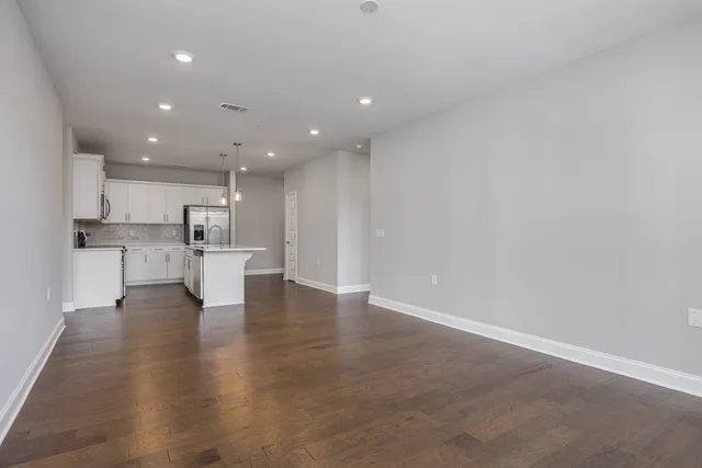 a view of kitchen dining table chairs microwave and cabinets