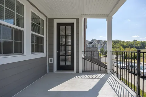 a view of a balcony with a floor to ceiling window and wooden floor