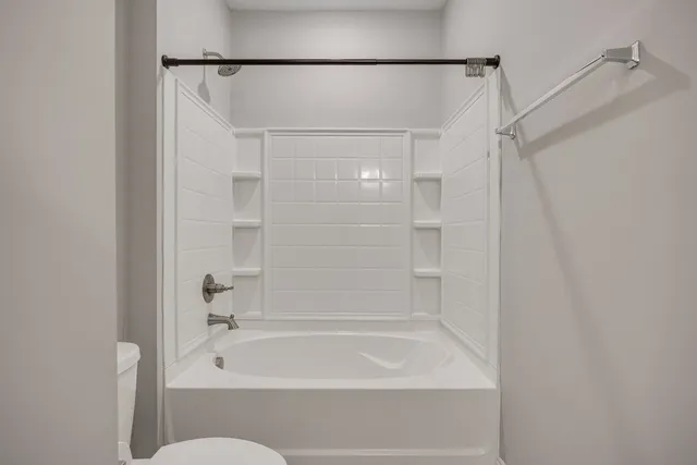 a bathroom with a shower and a bath tub