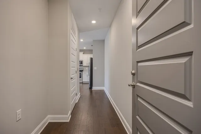 a view of hallway with stairs and wooden floor