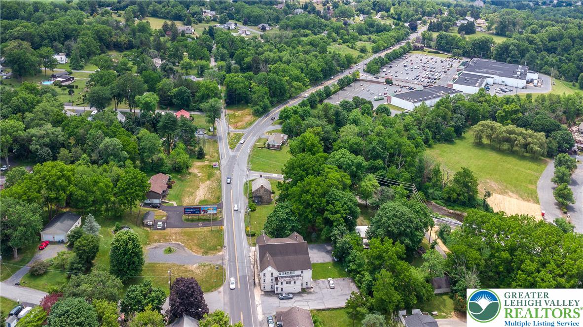1815 Leithsville Road Hellertown, PA 18055 - Photo 38 of 38 An aerial perspective reveals a vibrant neighborhood with abundant mature trees and winding roads.