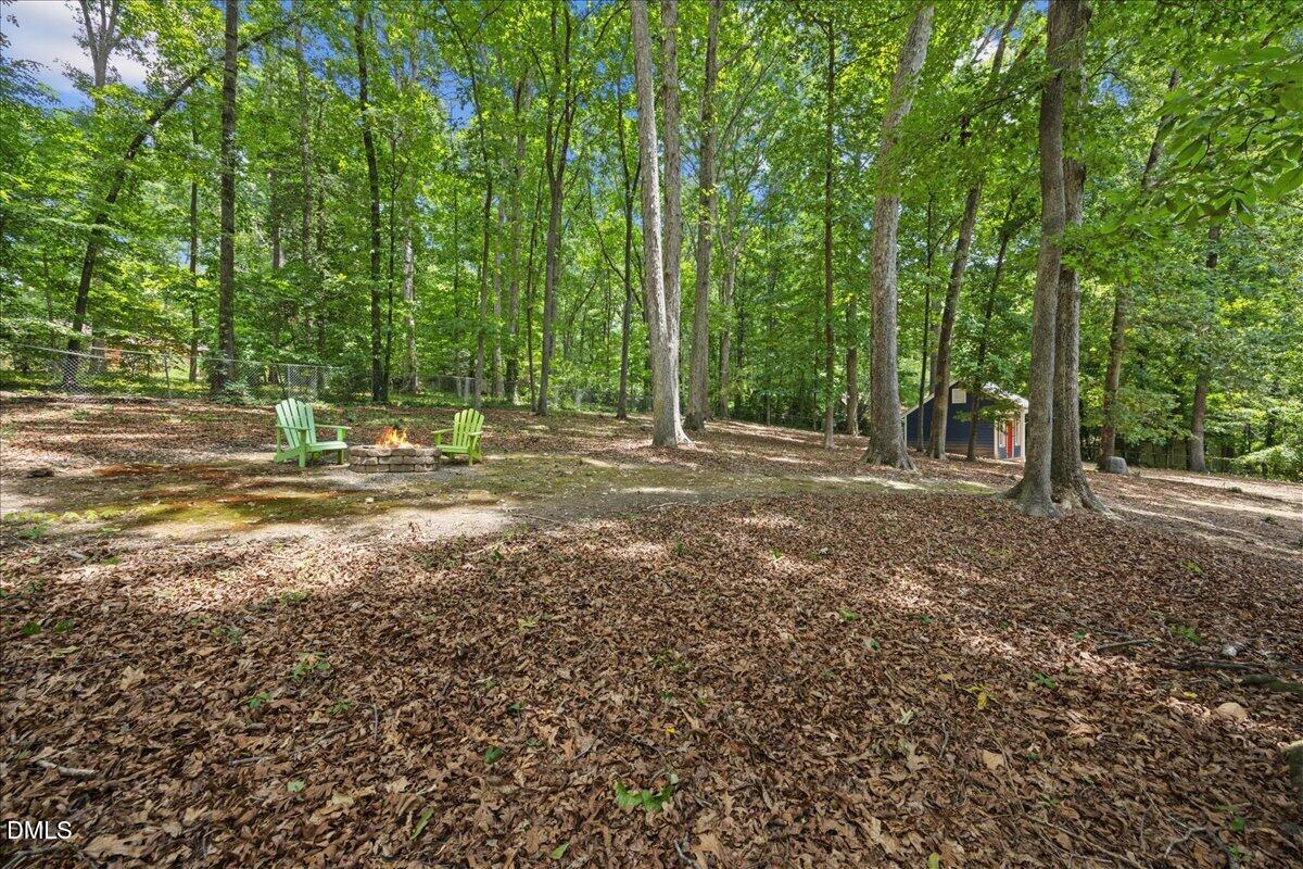 6516 Bakersfield Drive Raleigh, NC 27606 - Photo 50 of 59 a view of outdoor space with deck and trees
