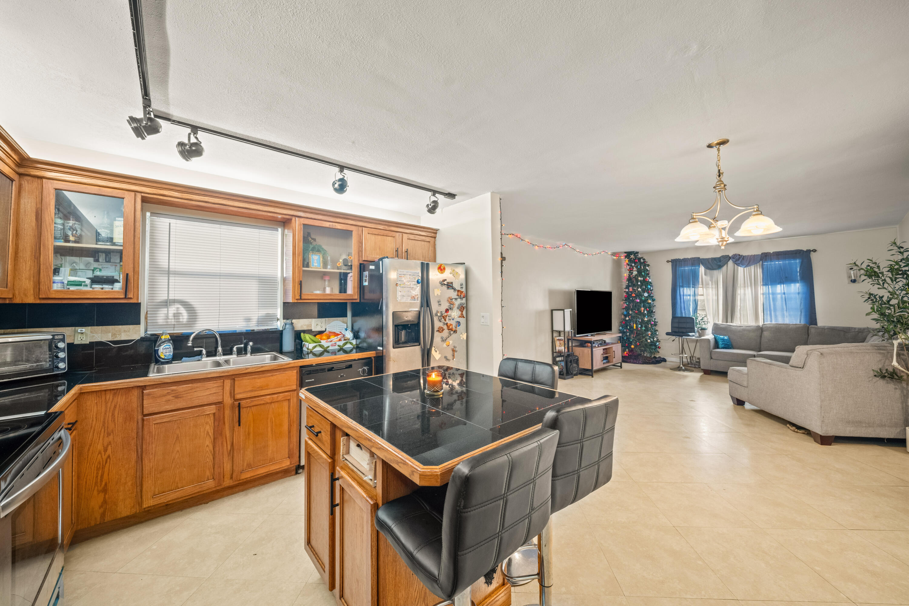 4528 Southwest 54th Street, Unit 302B Dania Beach, FL 33314 - Photo 1 of 33 a kitchen with granite countertop a sink counter top space and stainless steel appliances