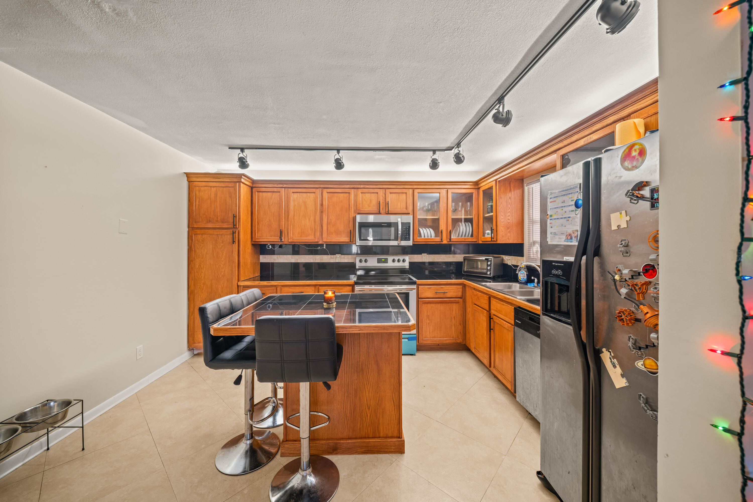 4528 Southwest 54th Street, Unit 302B Dania Beach, FL 33314 - Photo 13 of 33 a kitchen with granite countertop a sink and counter space