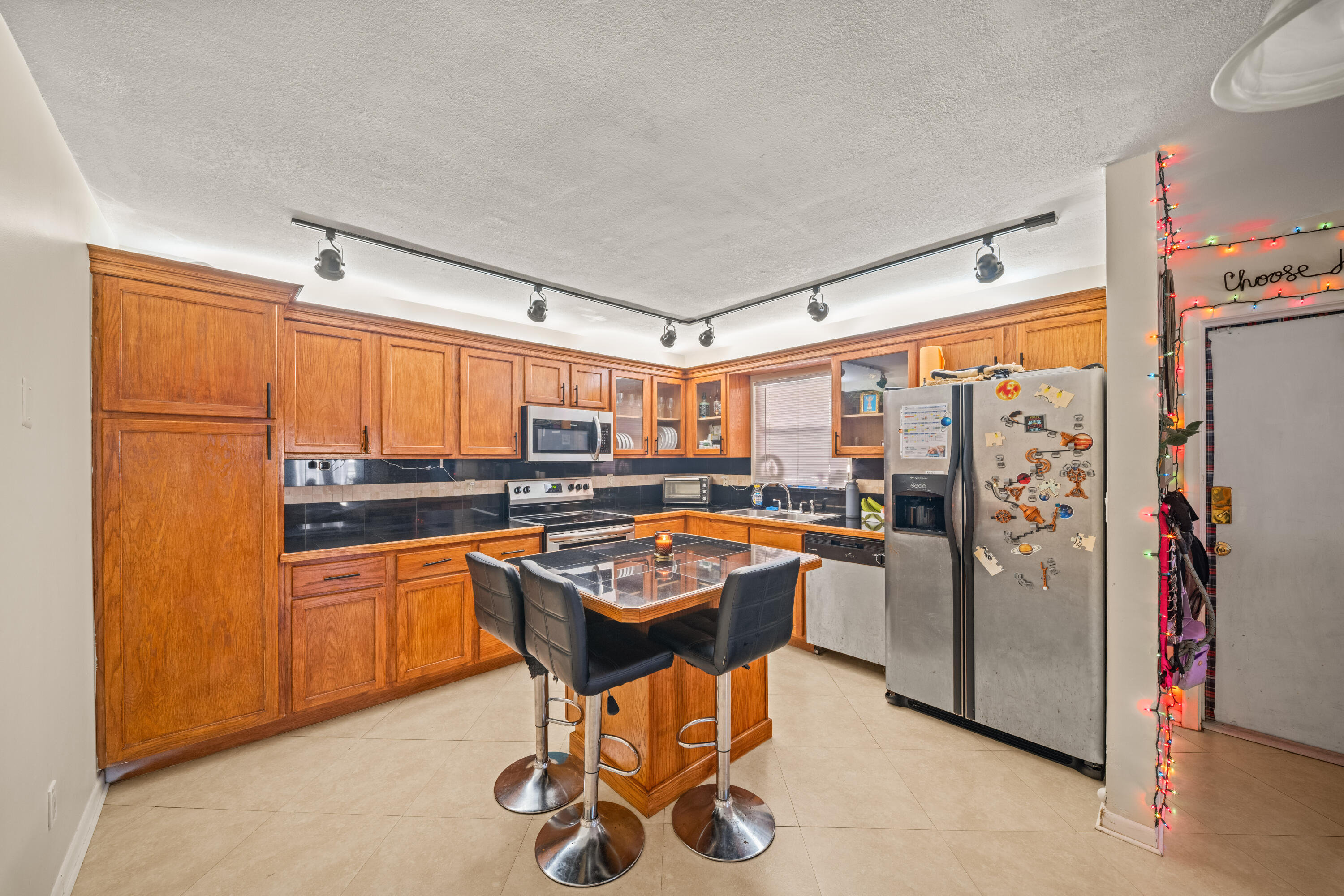 4528 Southwest 54th Street, Unit 302B Dania Beach, FL 33314 - Photo 14 of 33 a kitchen with stainless steel appliances granite countertop a refrigerator and a stove top oven