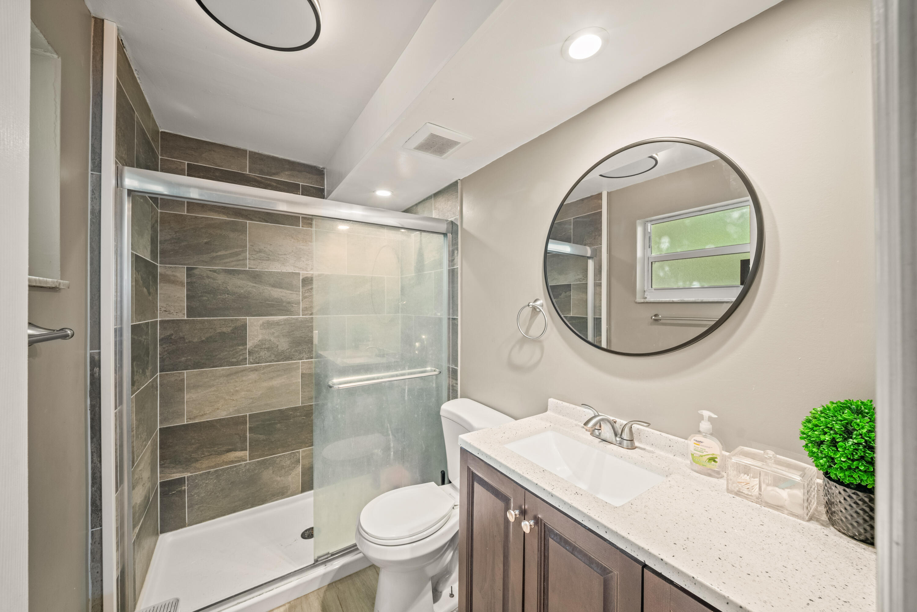 4528 Southwest 54th Street, Unit 302B Dania Beach, FL 33314 - Photo 4 of 33 a bathroom with a sink toilet and a mirror