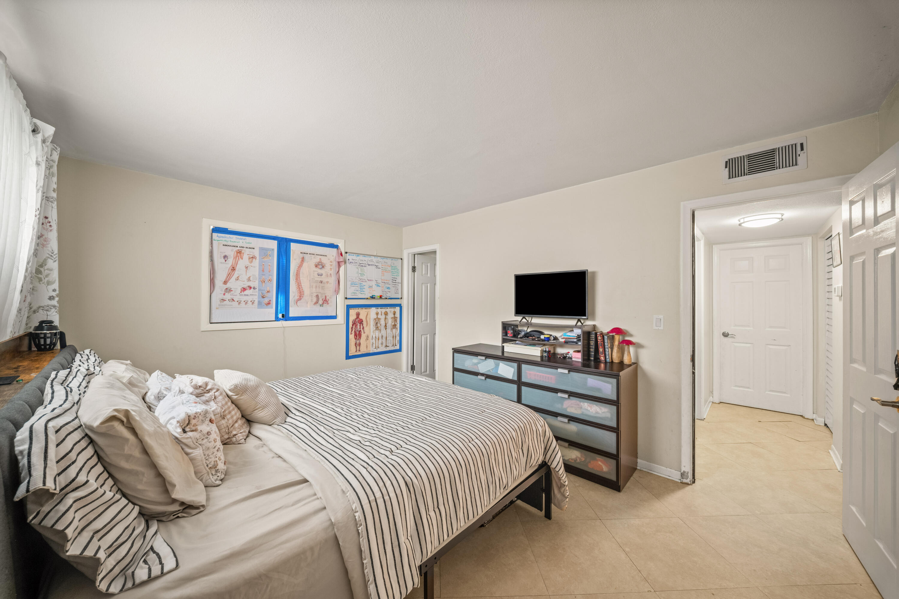 4528 Southwest 54th Street, Unit 302B Dania Beach, FL 33314 - Photo 10 of 33 a bedroom with a bed and a flat screen tv