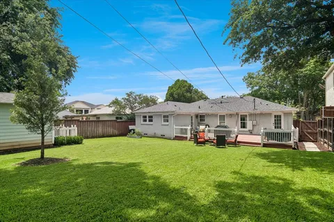 a view of a house with a yard and sitting area