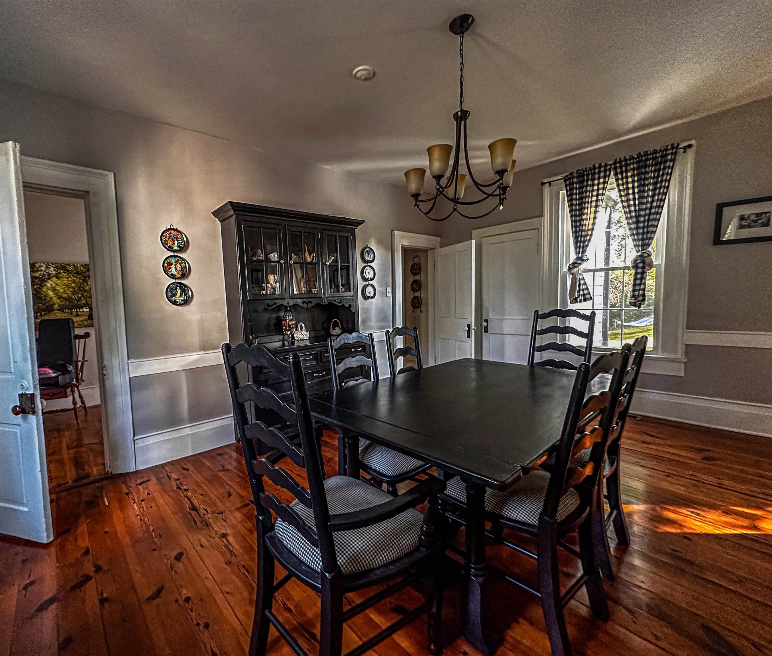 19 Mt Hermon Road Middlebrook, VA 24459 - Photo 44 of 70 a dining room with wooden floor a chandelier a wooden table and chairs