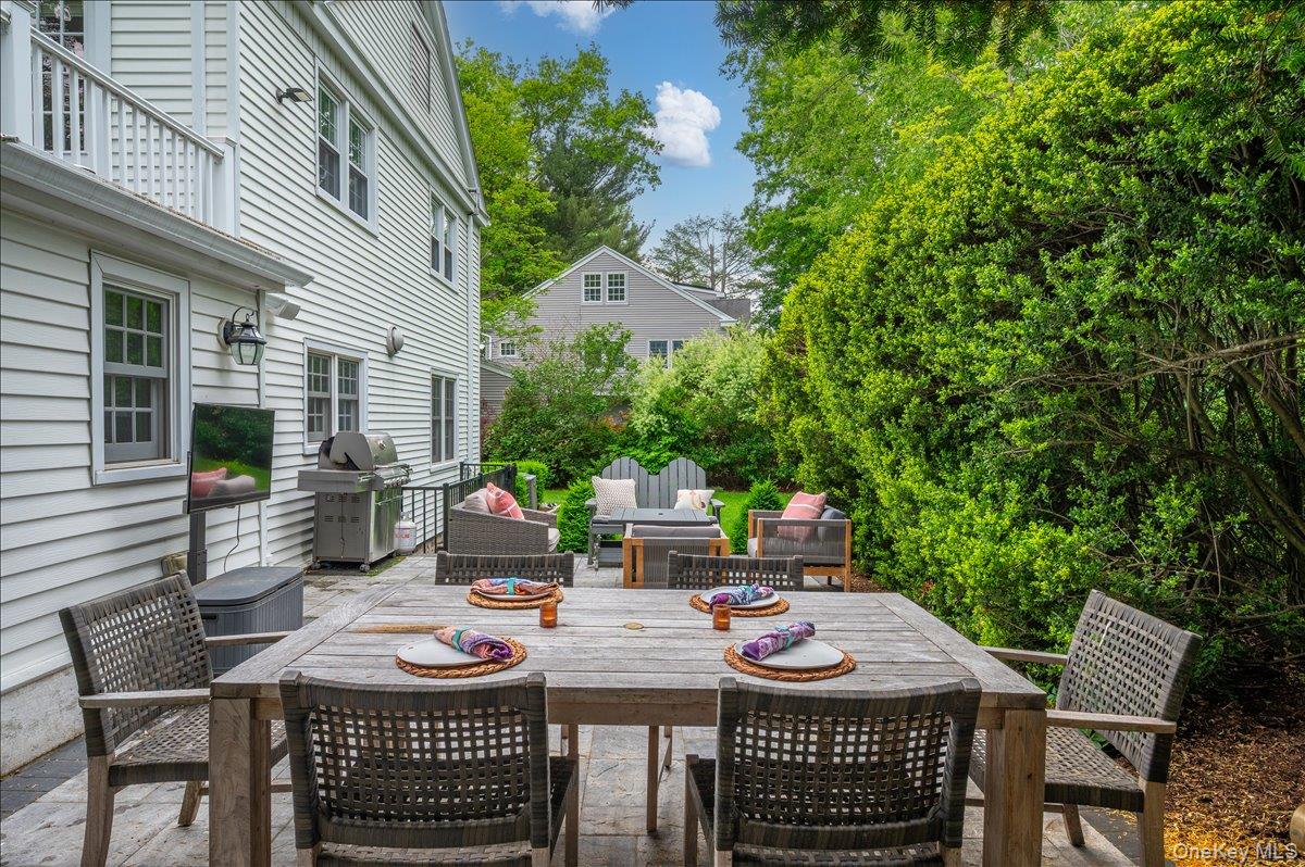 49 Eton Road Larchmont, NY 10538 - Photo 26 of 34 a view of a patio with table and chairs and potted plants