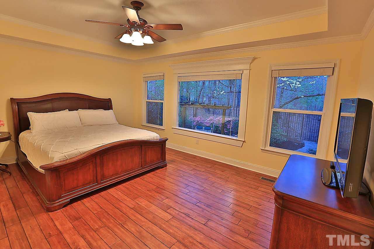 8536 Yucca Trail Raleigh, NC 27615 - Photo 5 of 23 a bedroom with a bed and wooden floor