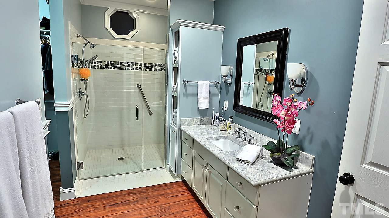8536 Yucca Trail Raleigh, NC 27615 - Photo 6 of 23 a bathroom with a sink mirror and shower