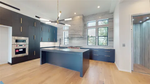 a kitchen with stainless steel appliances granite countertop a refrigerator a sink dishwasher with a dining table and chairs