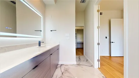 a view of walk in closet with white walls