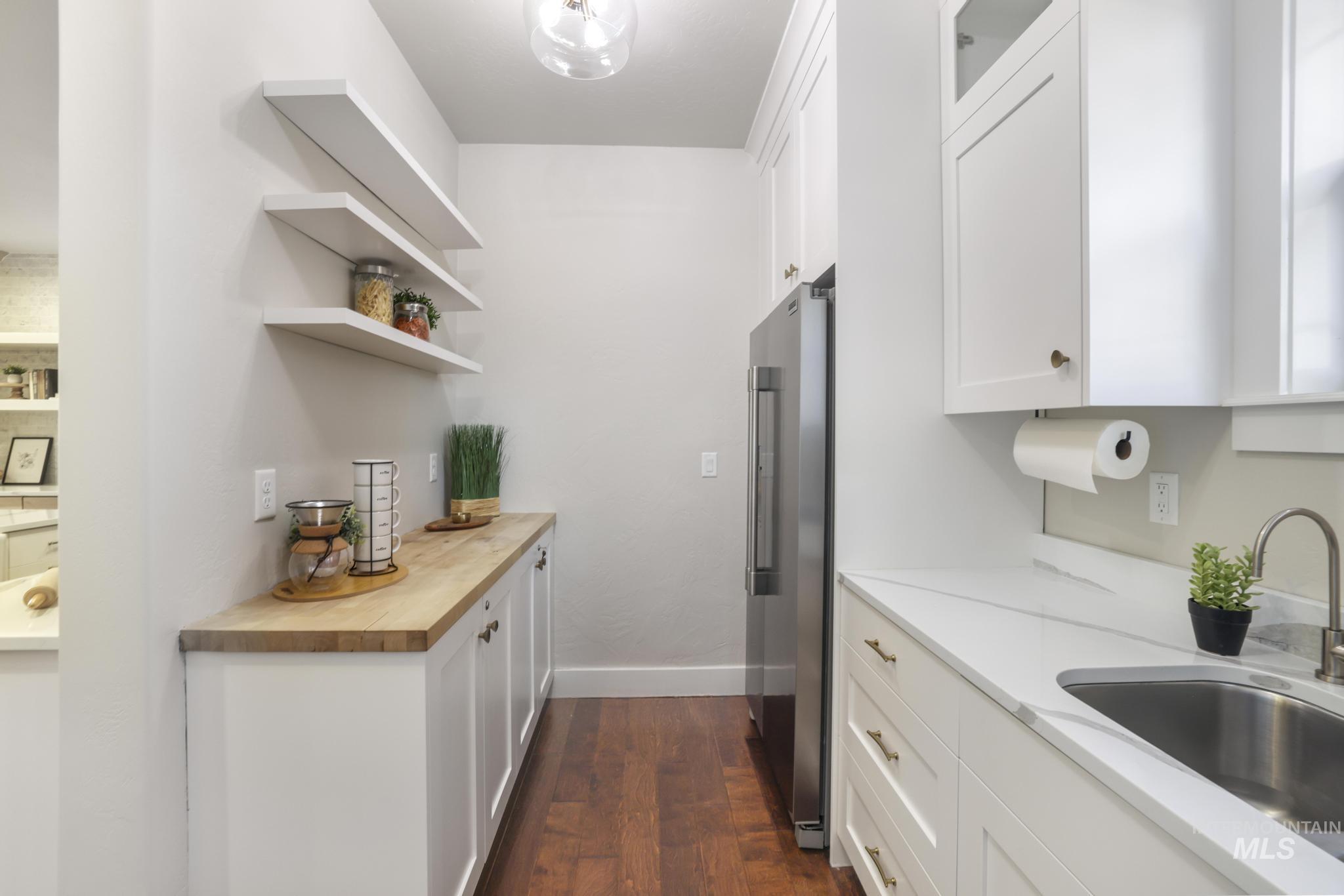 3365 Willow Way Twin Falls, ID 83301 - Photo 14 of 50 Kitchen featuring white cabinets, open shelves, high quality fridge, dark wood-style floors, and butcher block countertops