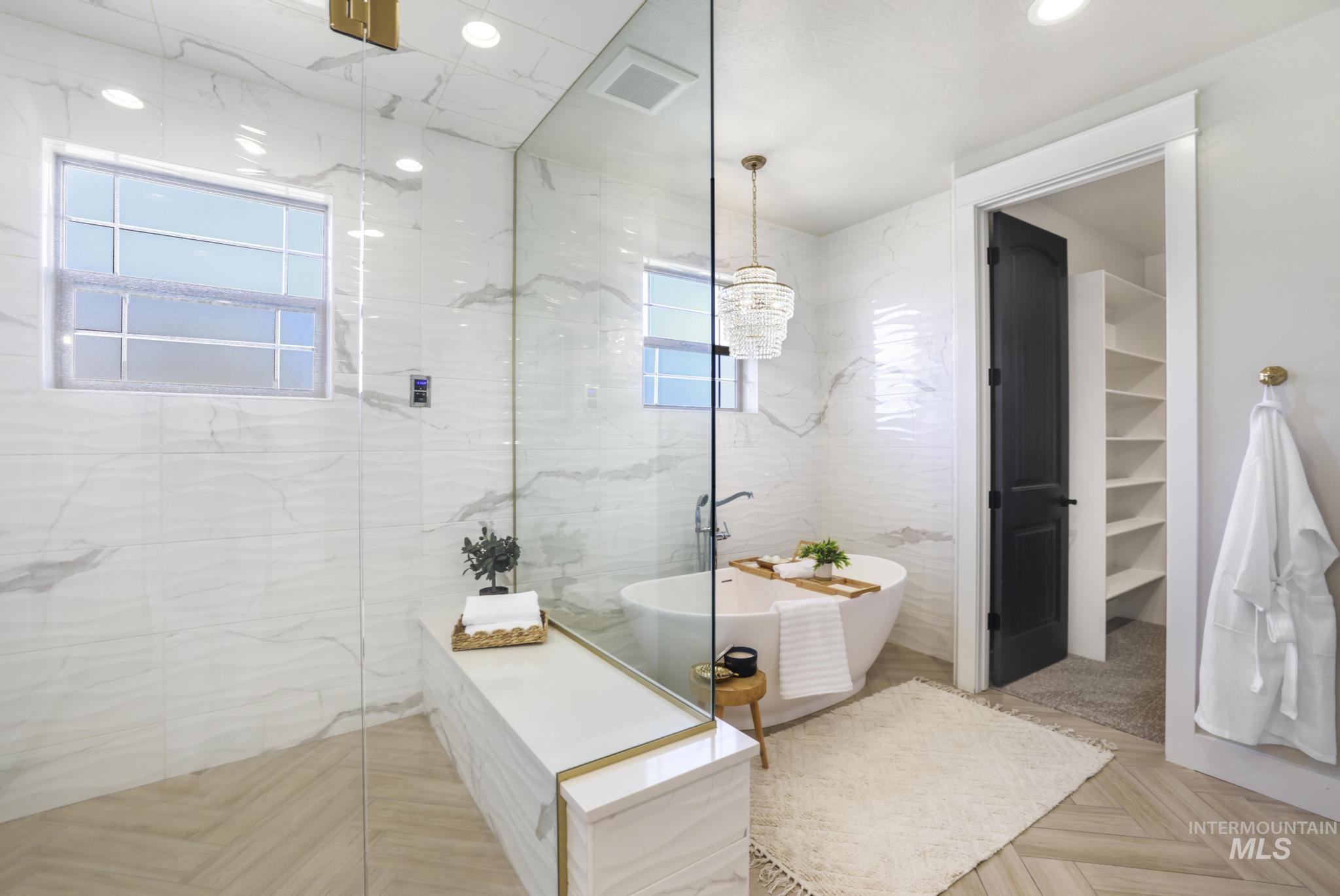 3365 Willow Way Twin Falls, ID 83301 - Photo 20 of 50 Bathroom with a marble finish shower, tile walls, a freestanding bath, parquet floors, and a walk in closet