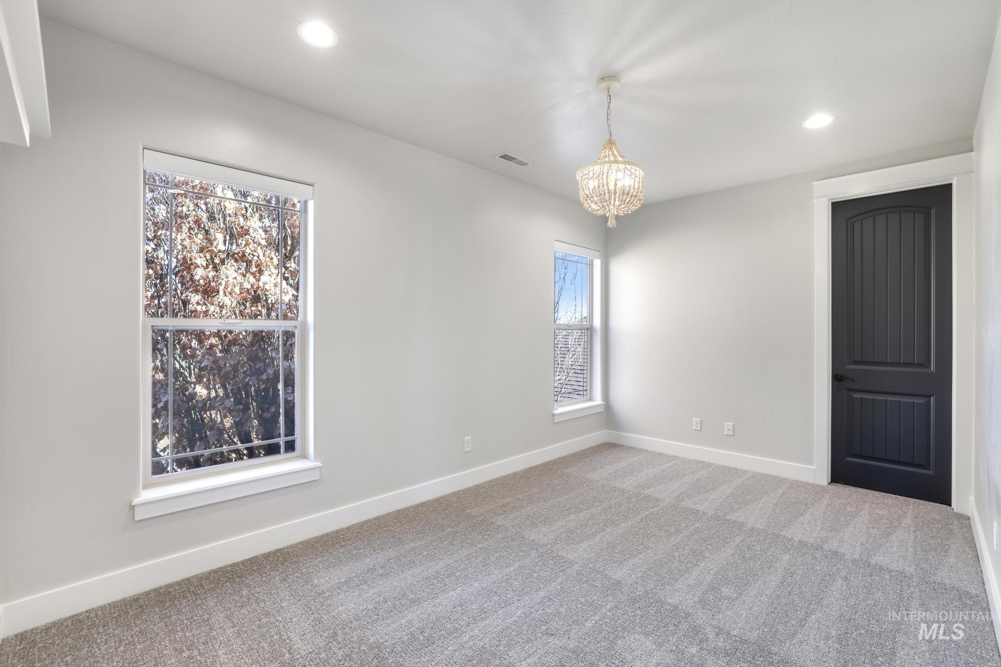 3365 Willow Way Twin Falls, ID 83301 - Photo 33 of 50 Carpeted empty room featuring baseboards and a chandelier