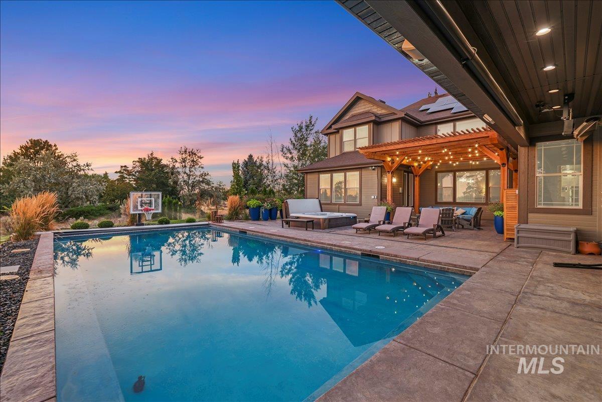 3365 Willow Way Twin Falls, ID 83301 - Photo 4 of 50 Outdoor pool featuring a jacuzzi, a patio area, and a pergola