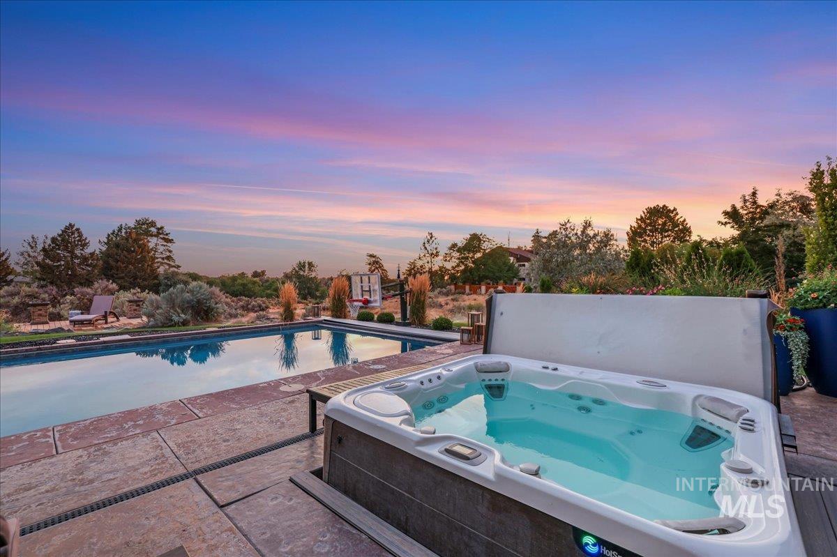 3365 Willow Way Twin Falls, ID 83301 - Photo 6 of 50 Pool at dusk with a hot tub and a patio area