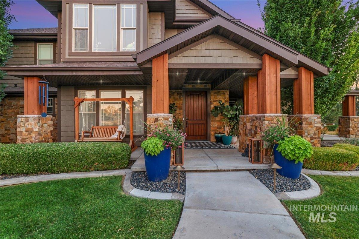 3365 Willow Way Twin Falls, ID 83301 - Photo 7 of 50 Exterior entry at dusk with stone siding, covered porch, and a yard