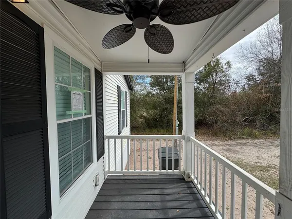 a view of a porch with wooden floor and outdoor space